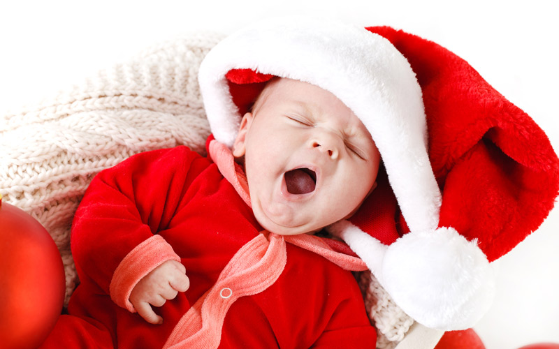 Baby dressed as Santa Claus