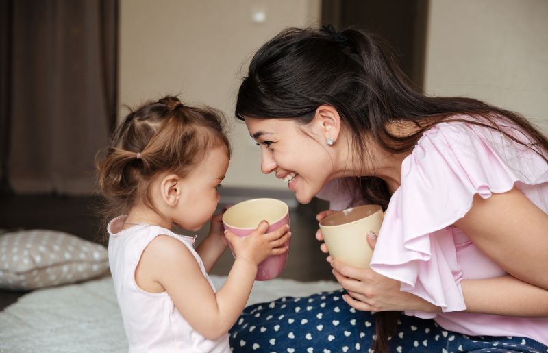 Mom and daughter drinking tea